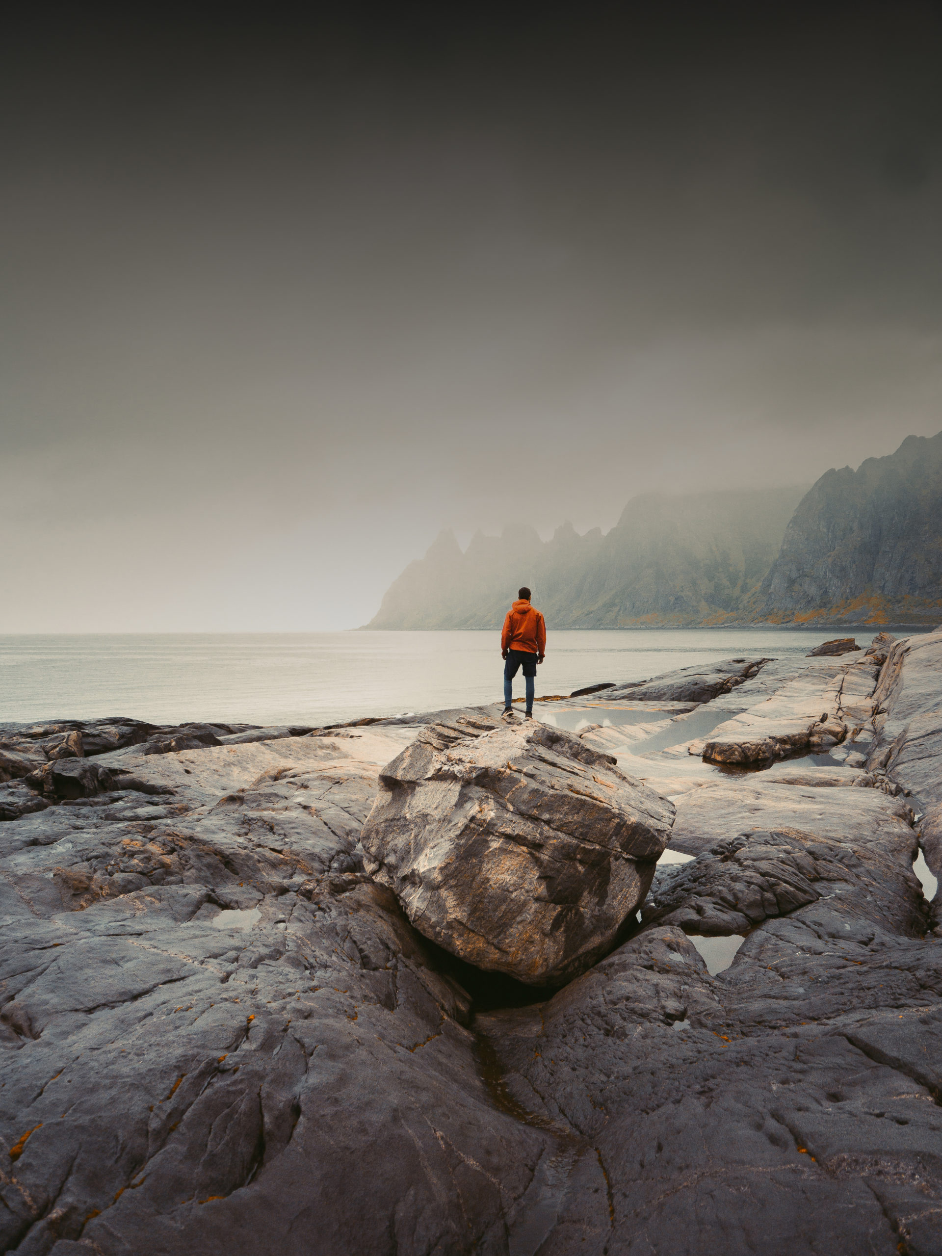 Adventurous man standing on stone. The Tungeneset rest area lie